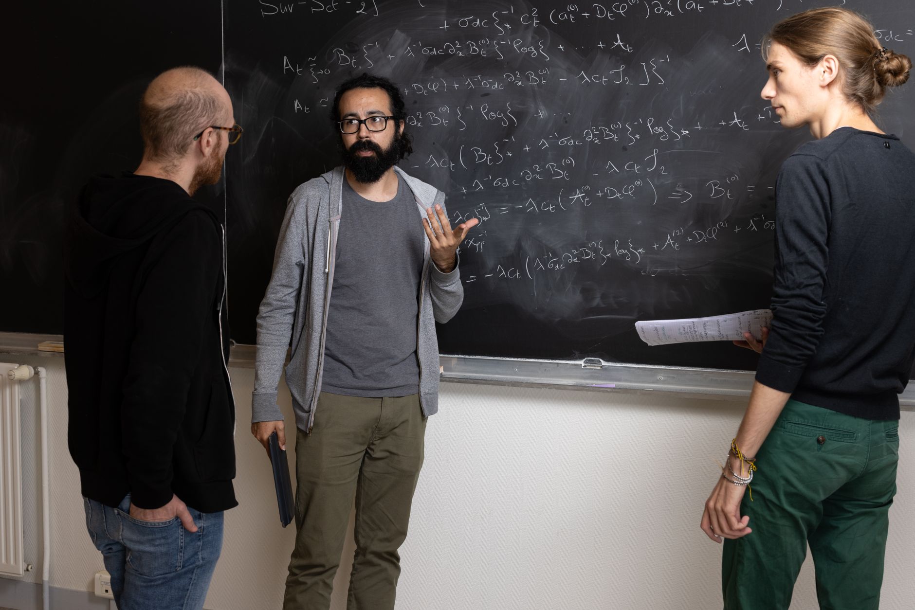mathematicians collaborate on chalkboard equations