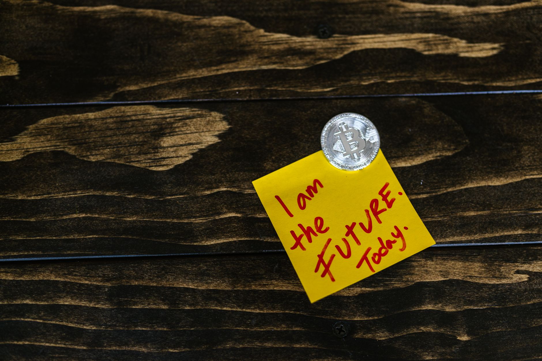 yellow post it on a wooden surface