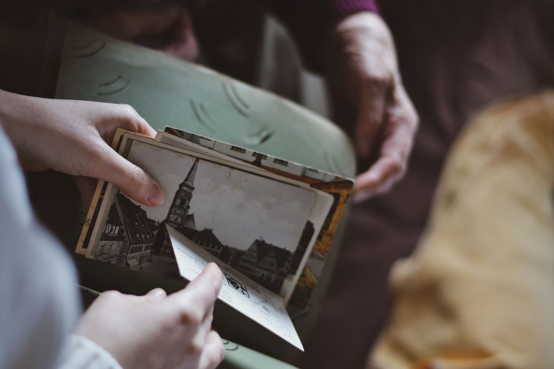 woman hands holding black and white pictures