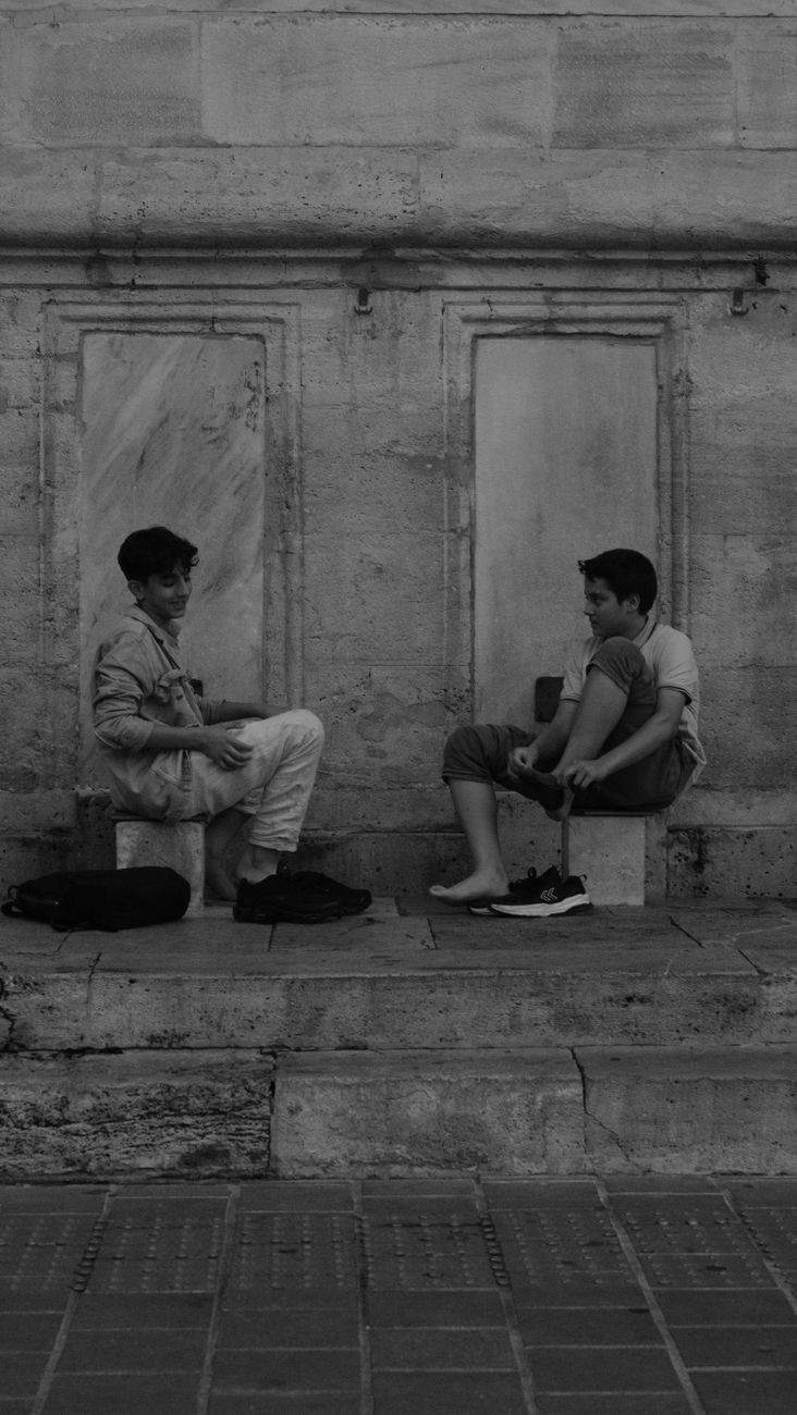 candid conversation between two boys on steps