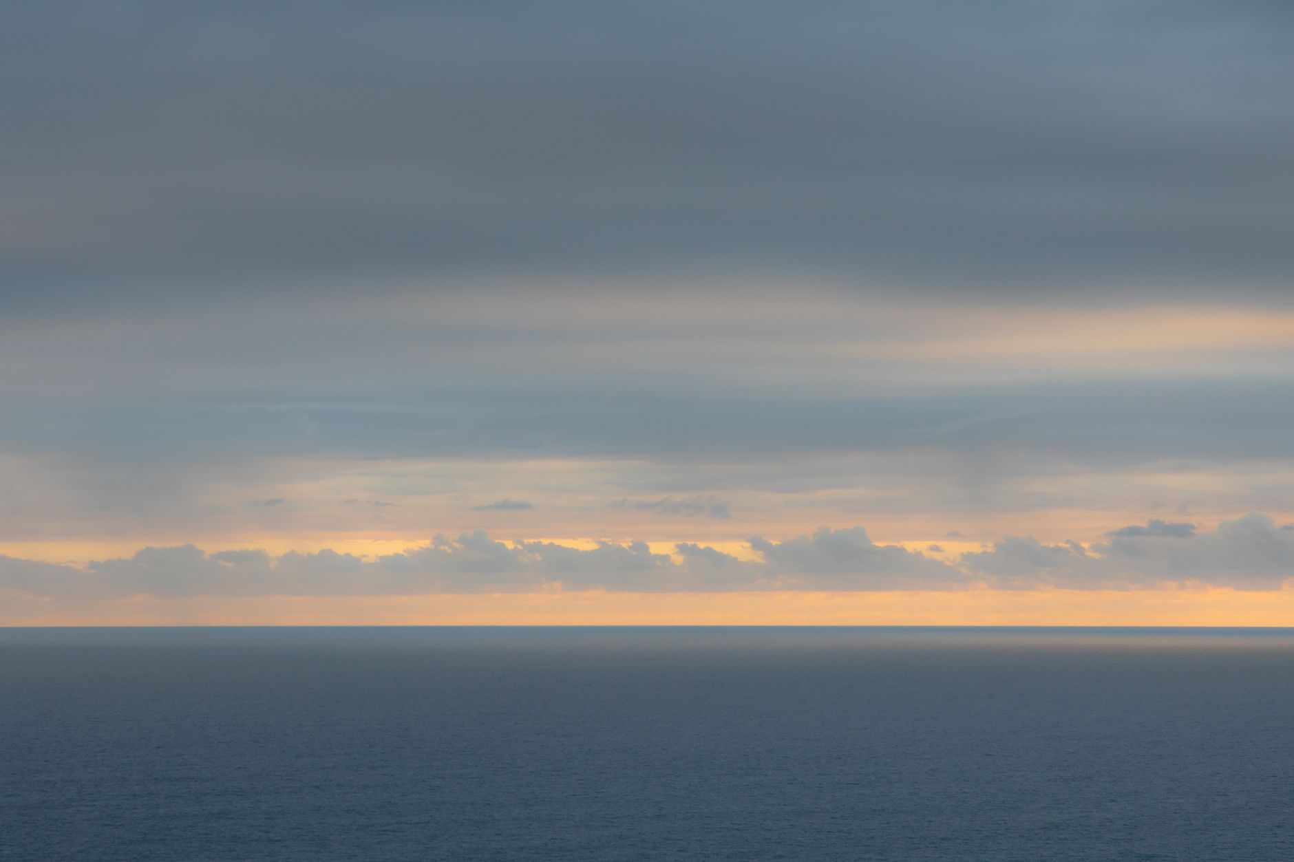 body of water under cloudy sky