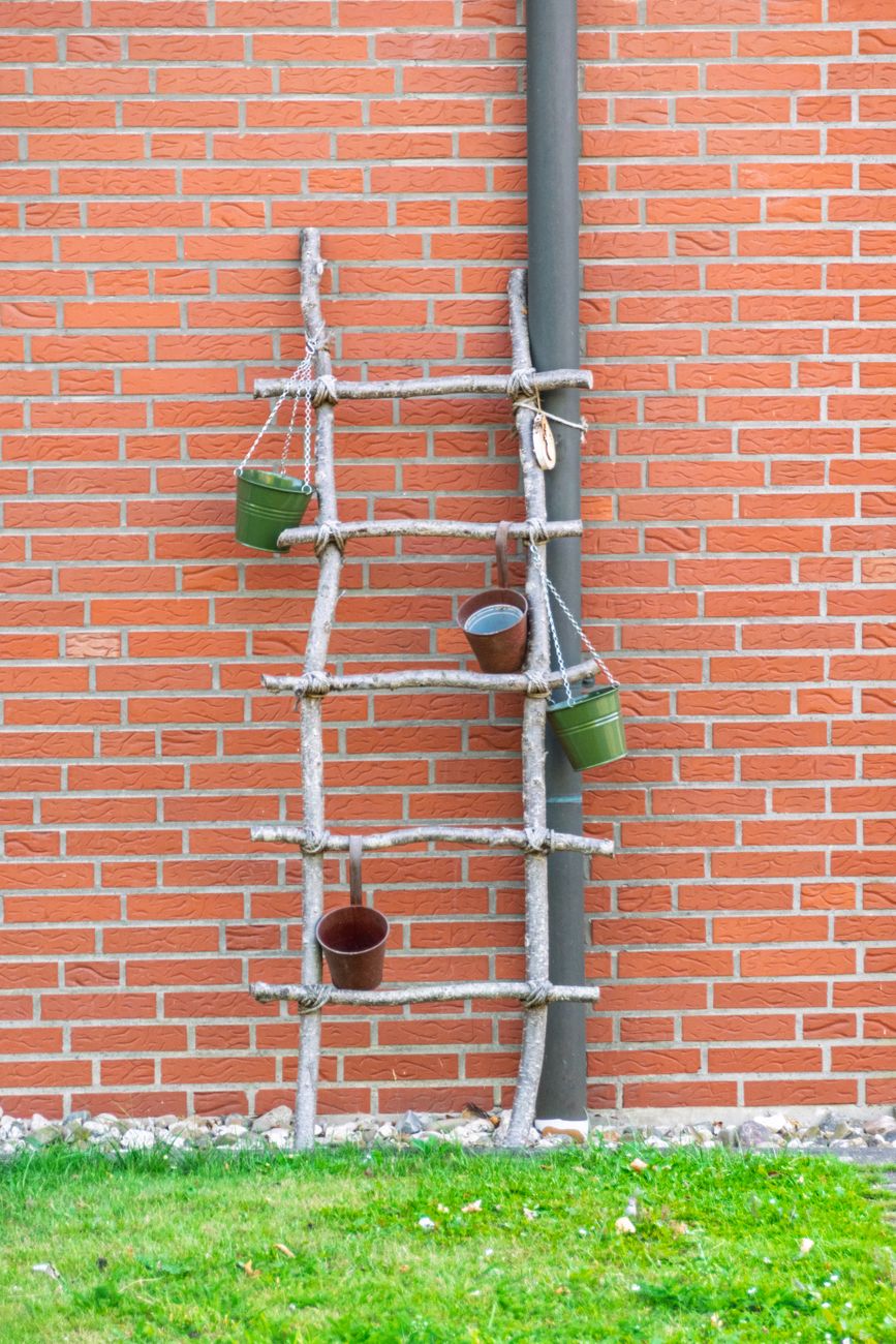 rustic ladder garden decor on brick wall