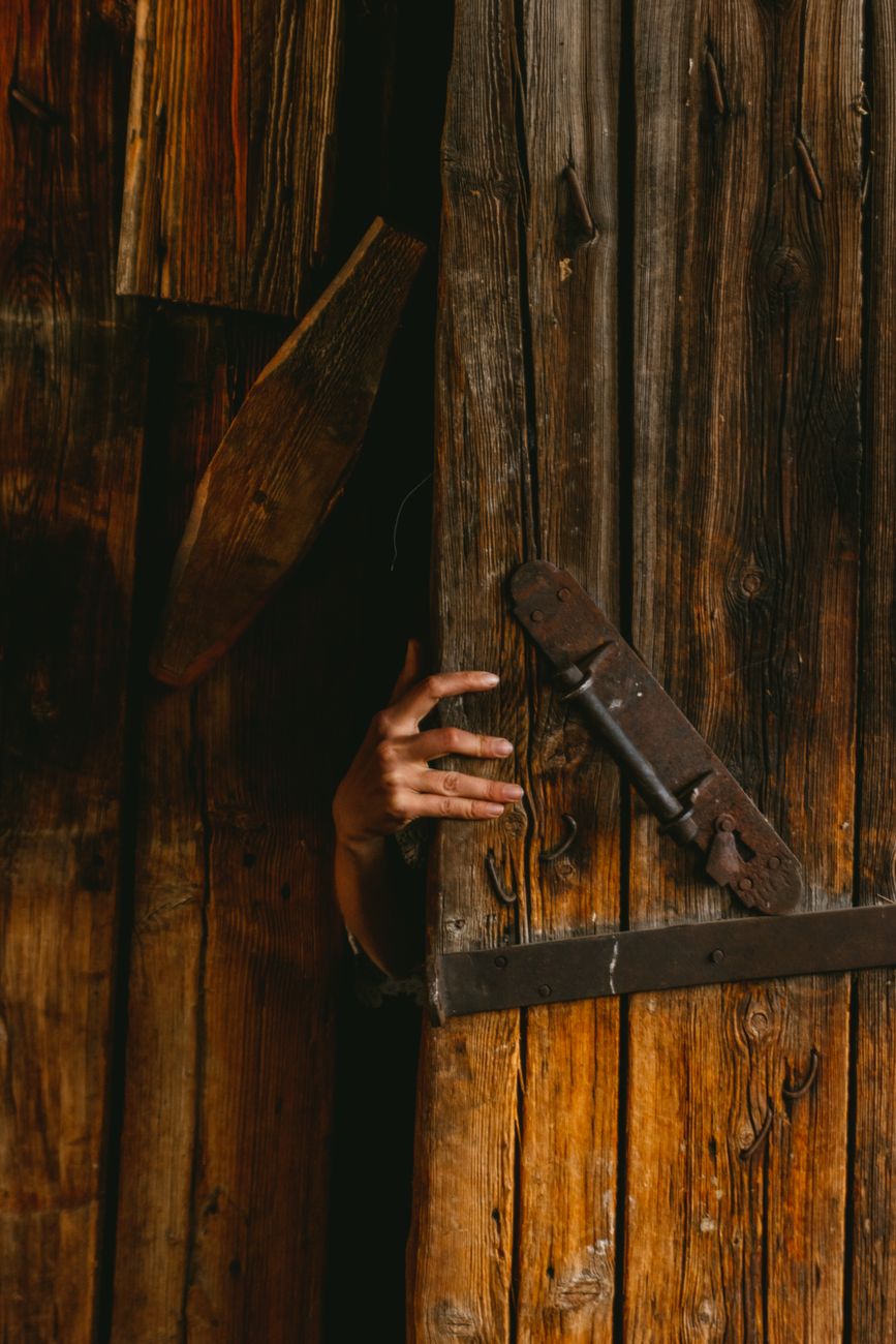 woman hand opening wooden door