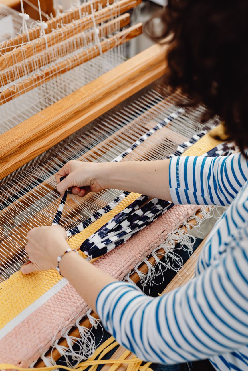 a person weaving fabric