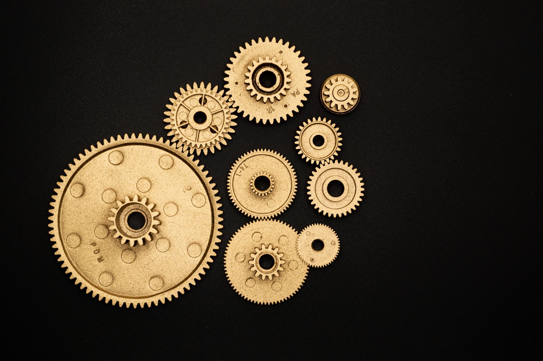 photo of golden cogwheel on black background