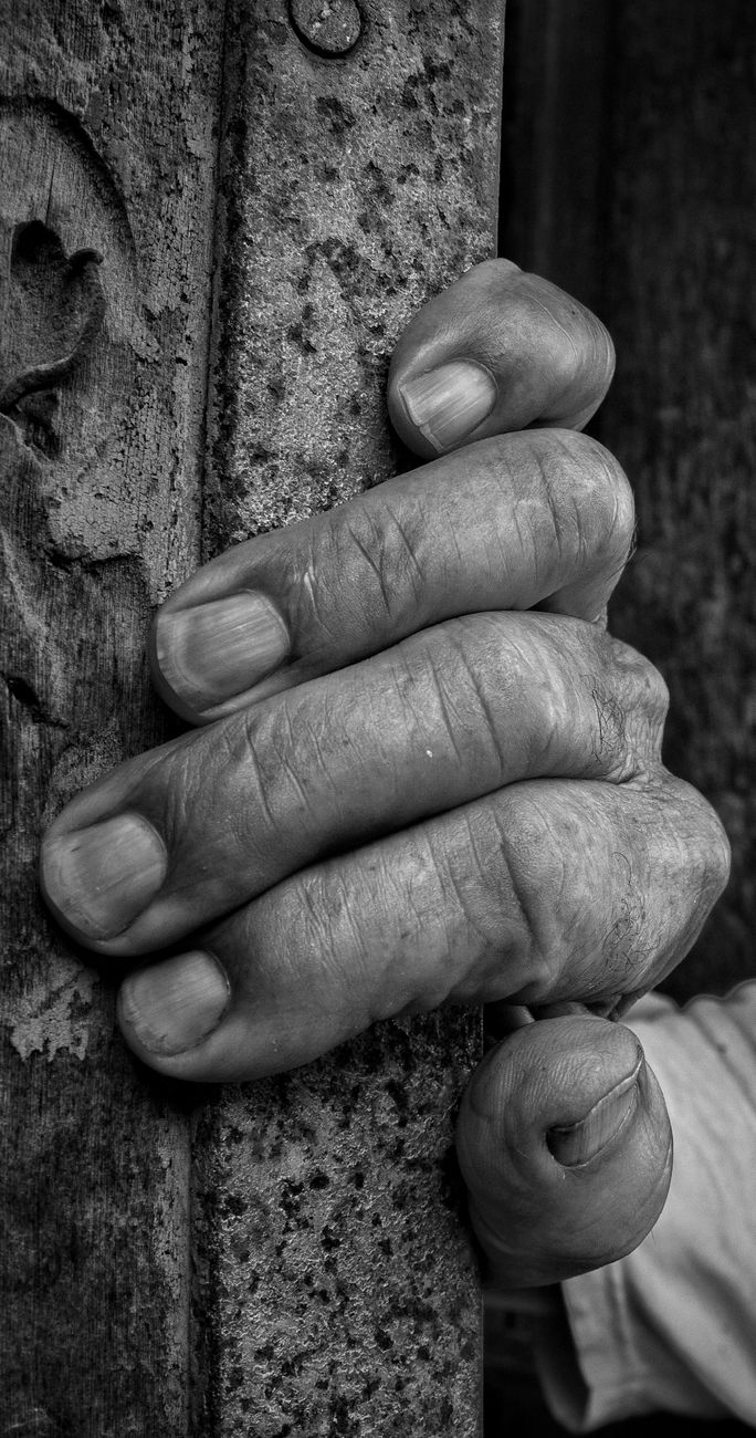 close up of hand holding wall