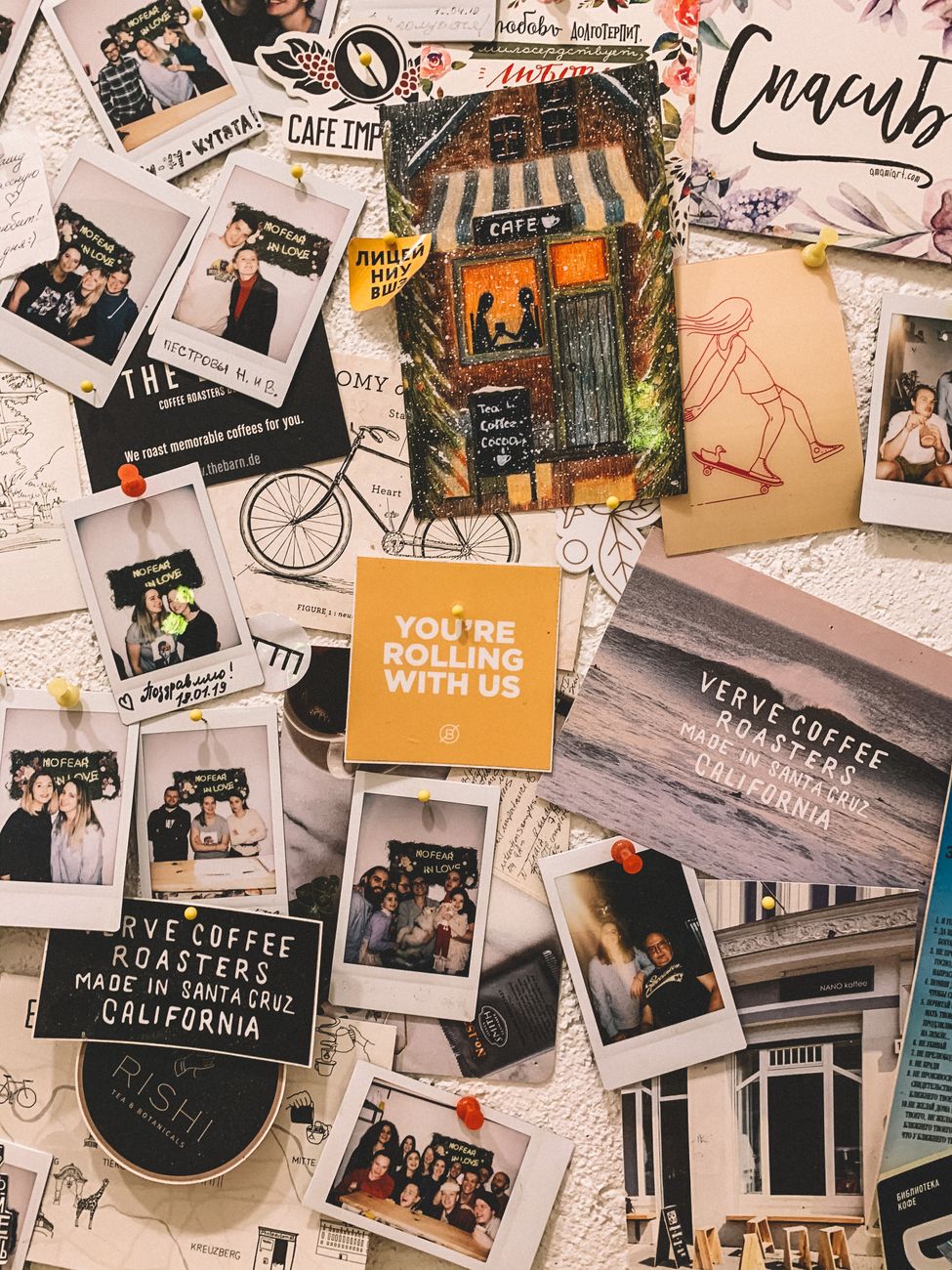 polaroid photos and quotes posted on a wall