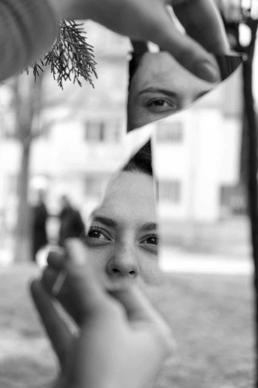 shards of a broken mirror held by a young woman
