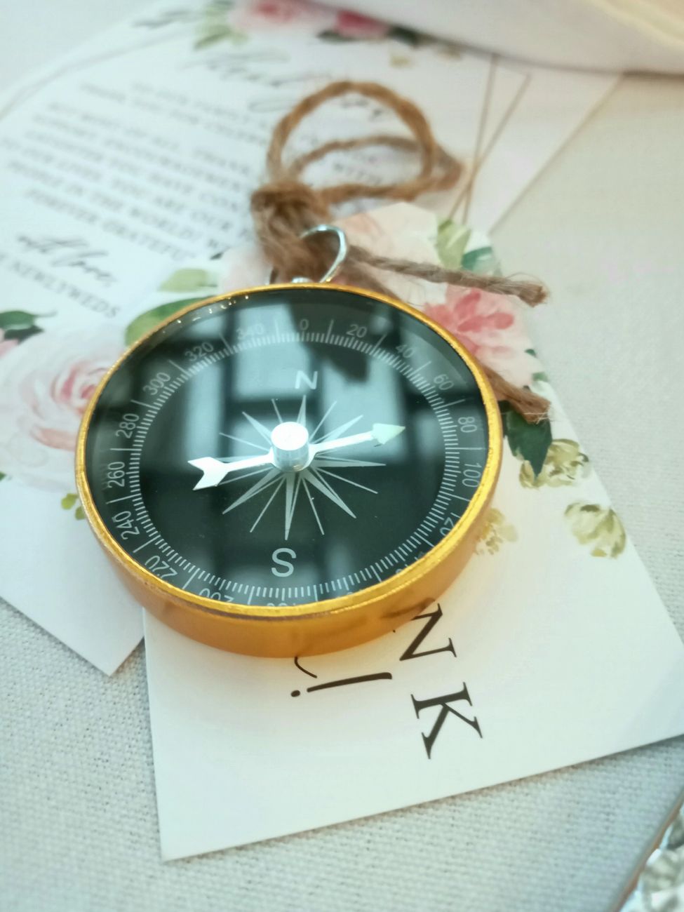 gold and silver round compass