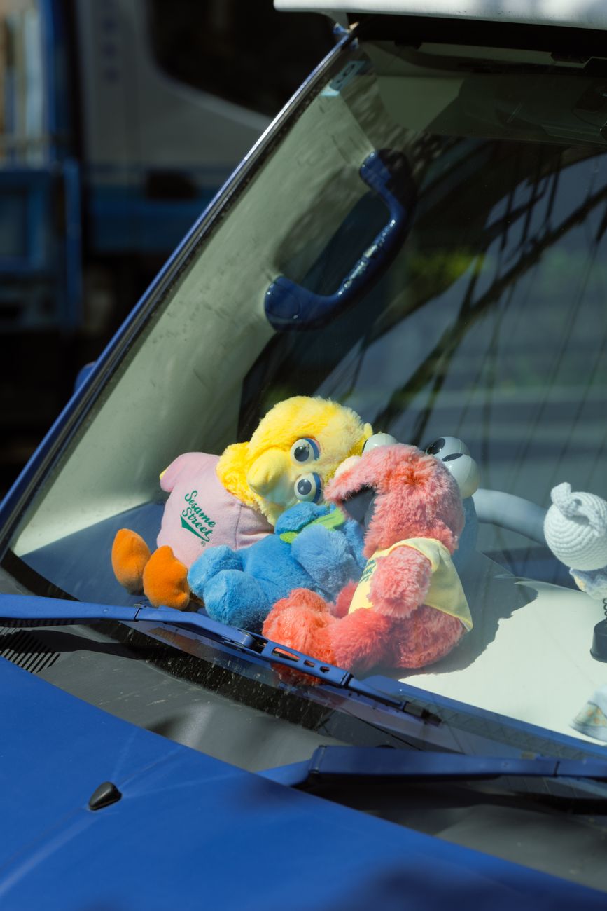 colorful plush toys on a car dashboard