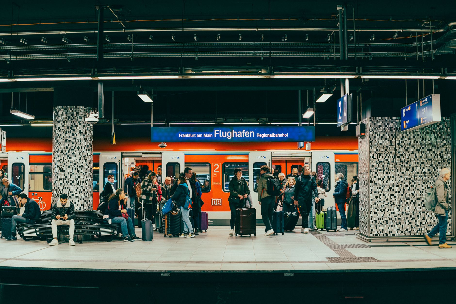 busy frankfurt airport train station platform scene