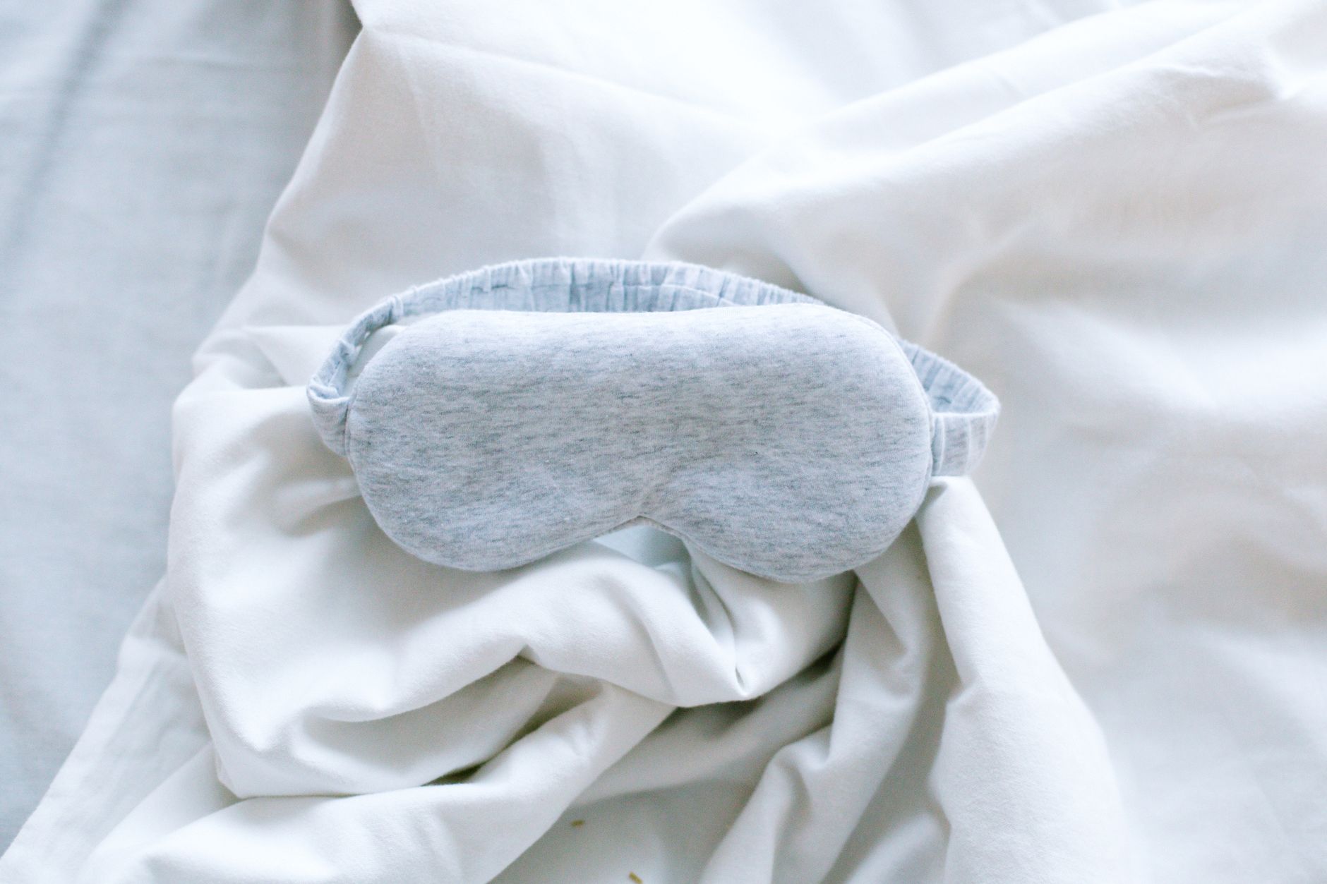 a gray garterized eye cap on a white textile