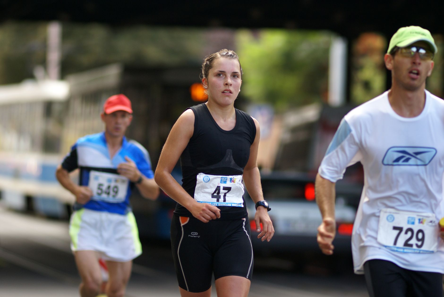 a woman in a black and white shirt running in a race