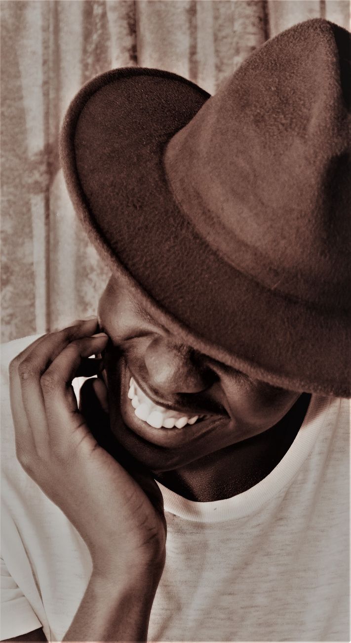smiling man in hat