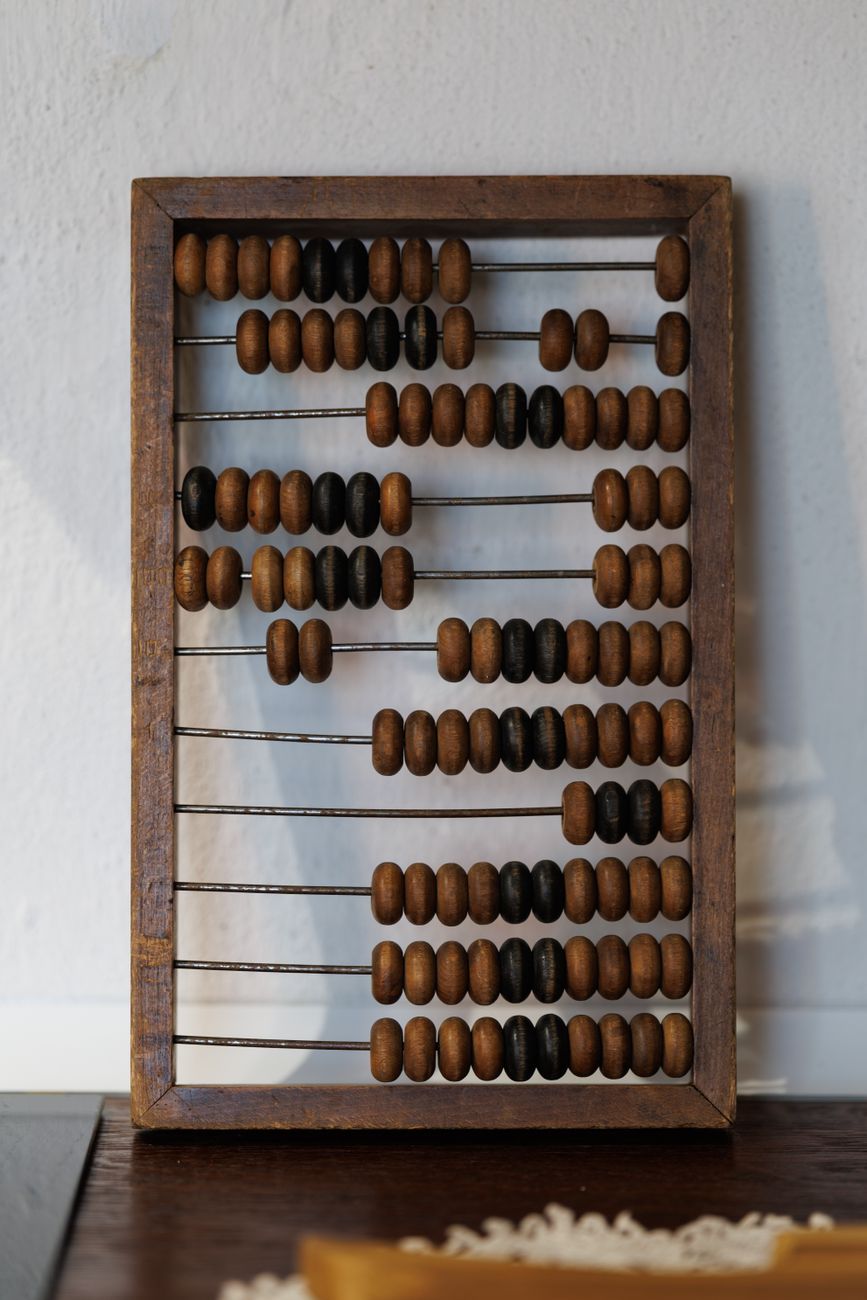 traditional wooden abacus against white wall