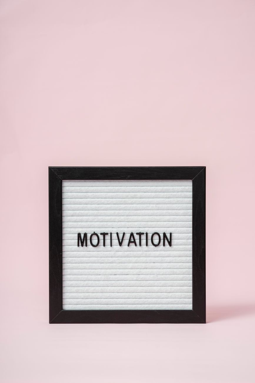 a letter board with a pink background