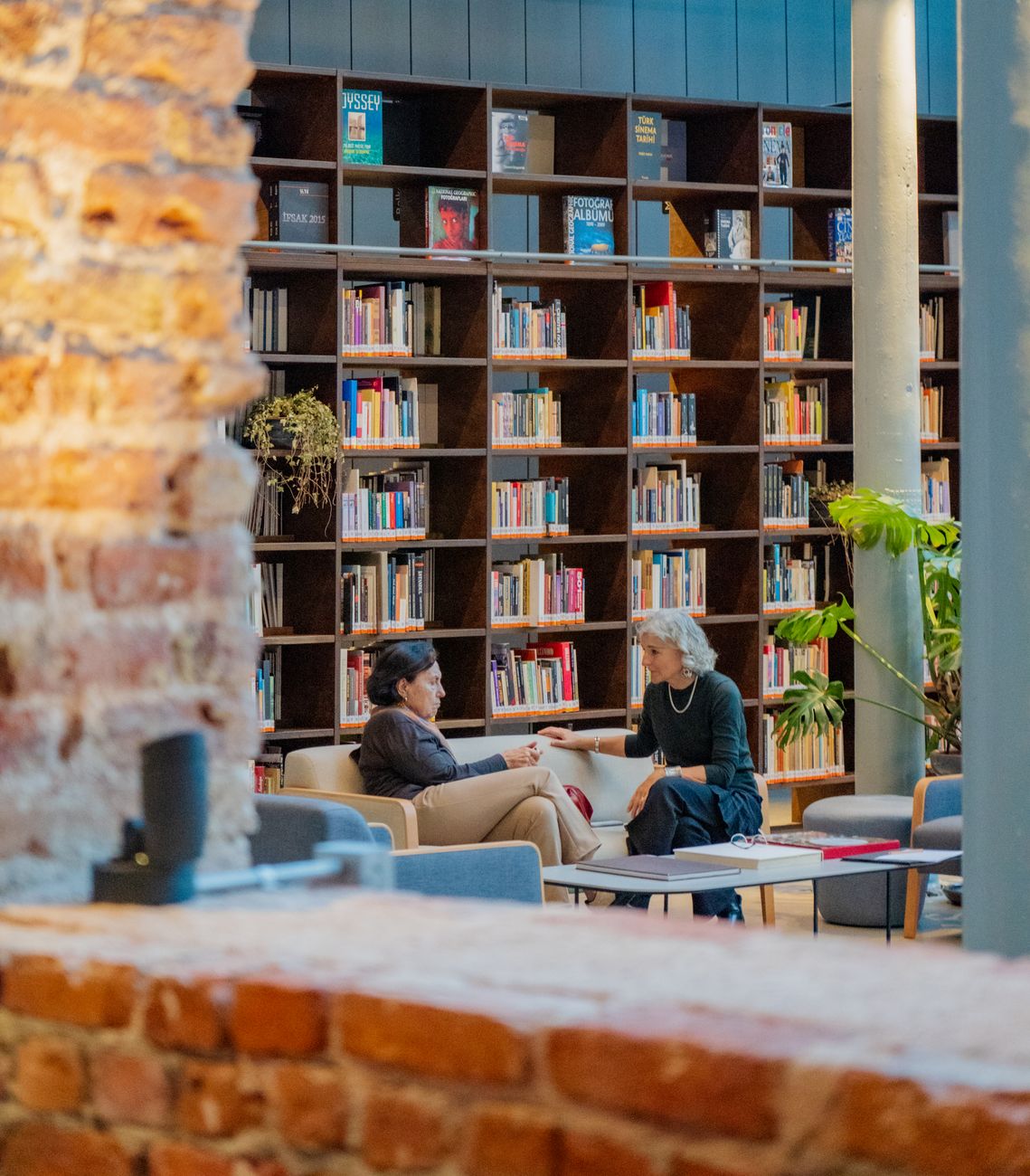 women sitting and talking at library