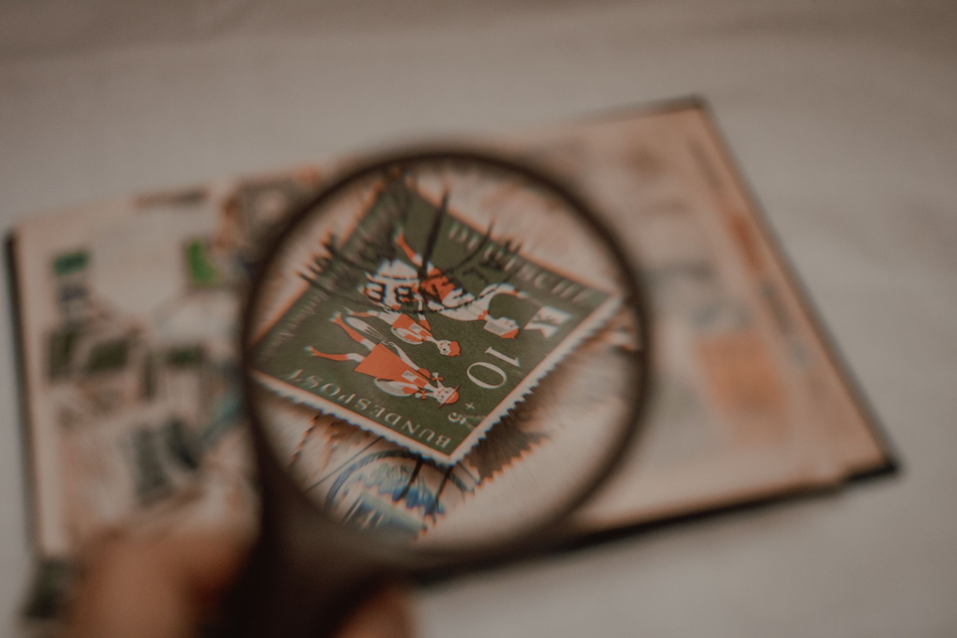 a postal stamp under a magnifying glass