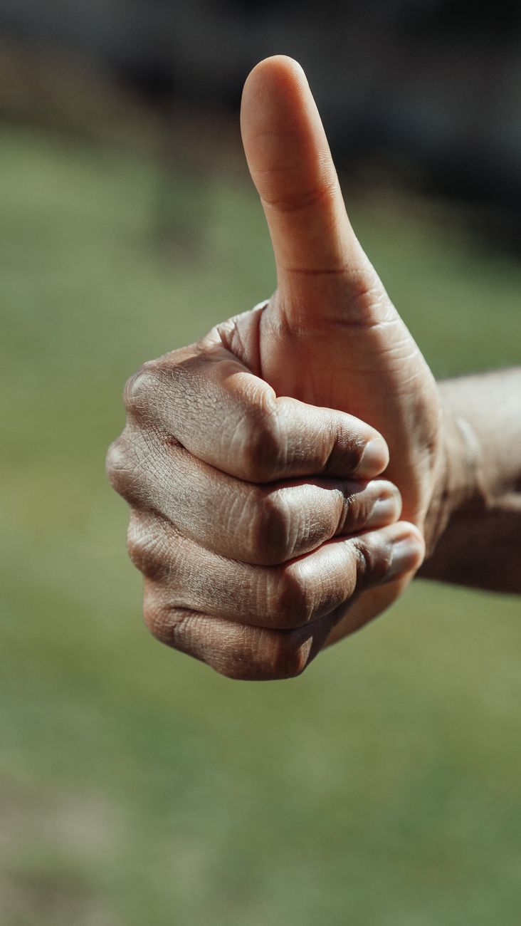 close up shot of a thumbs up