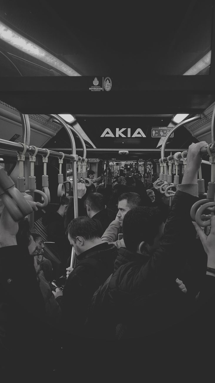 crowded bus interior in black and white