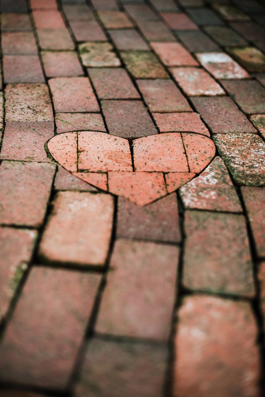 romantic heart shaped brick pattern on rustic pavement