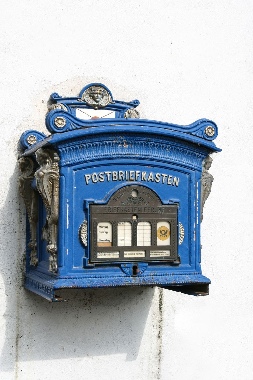 blue mailbox on the white wall