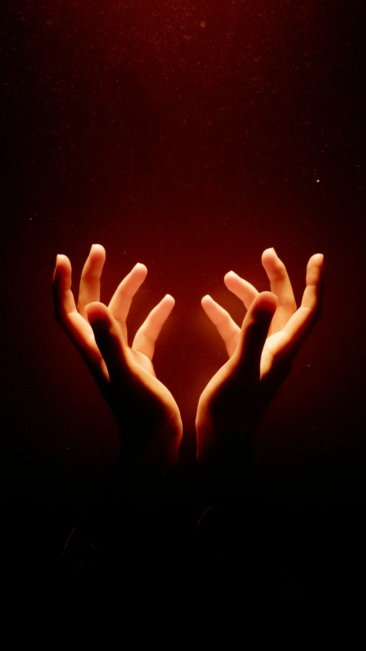 ethereal glow of outstretched hands