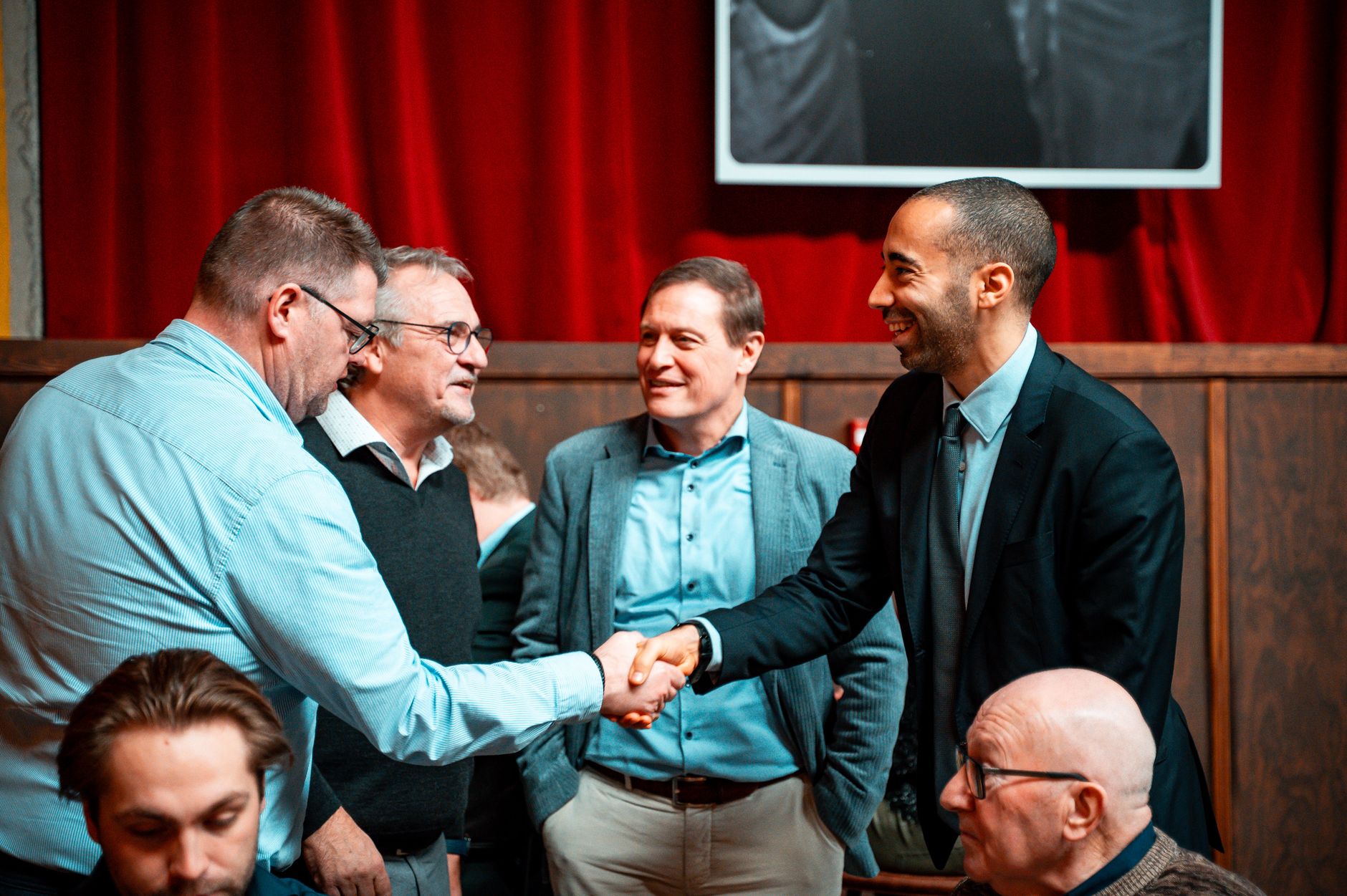 group of businessmen shaking hands at meeting