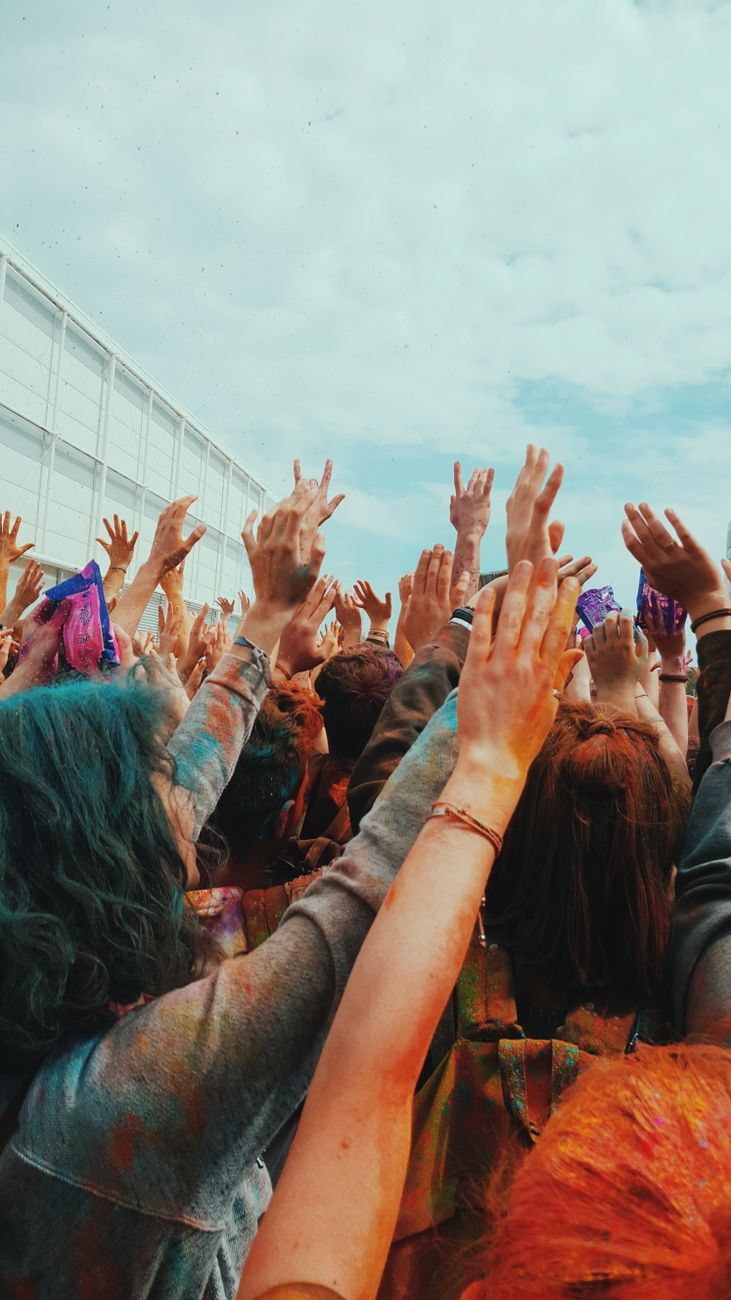 people raising their hands in a festival
