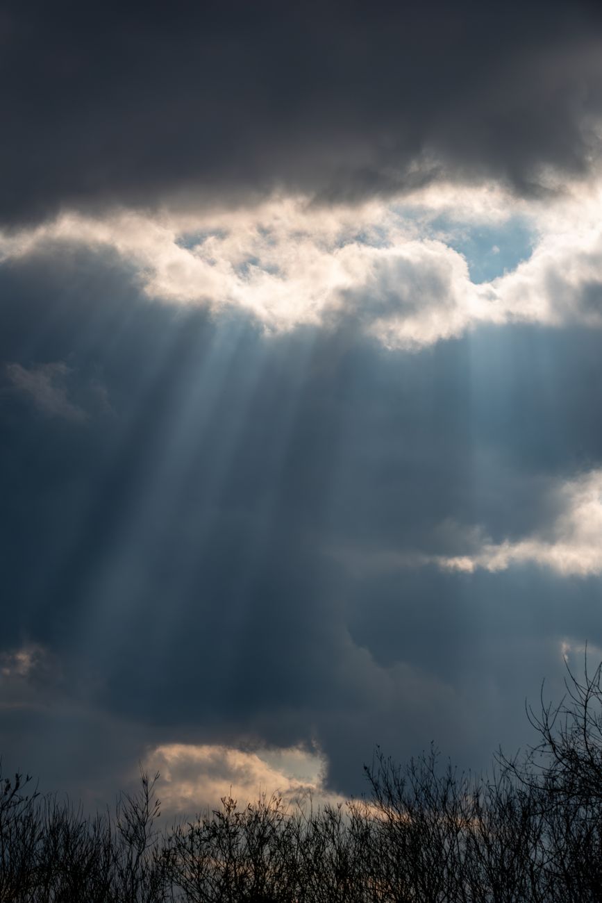 dramatic sun rays through dark clouds
