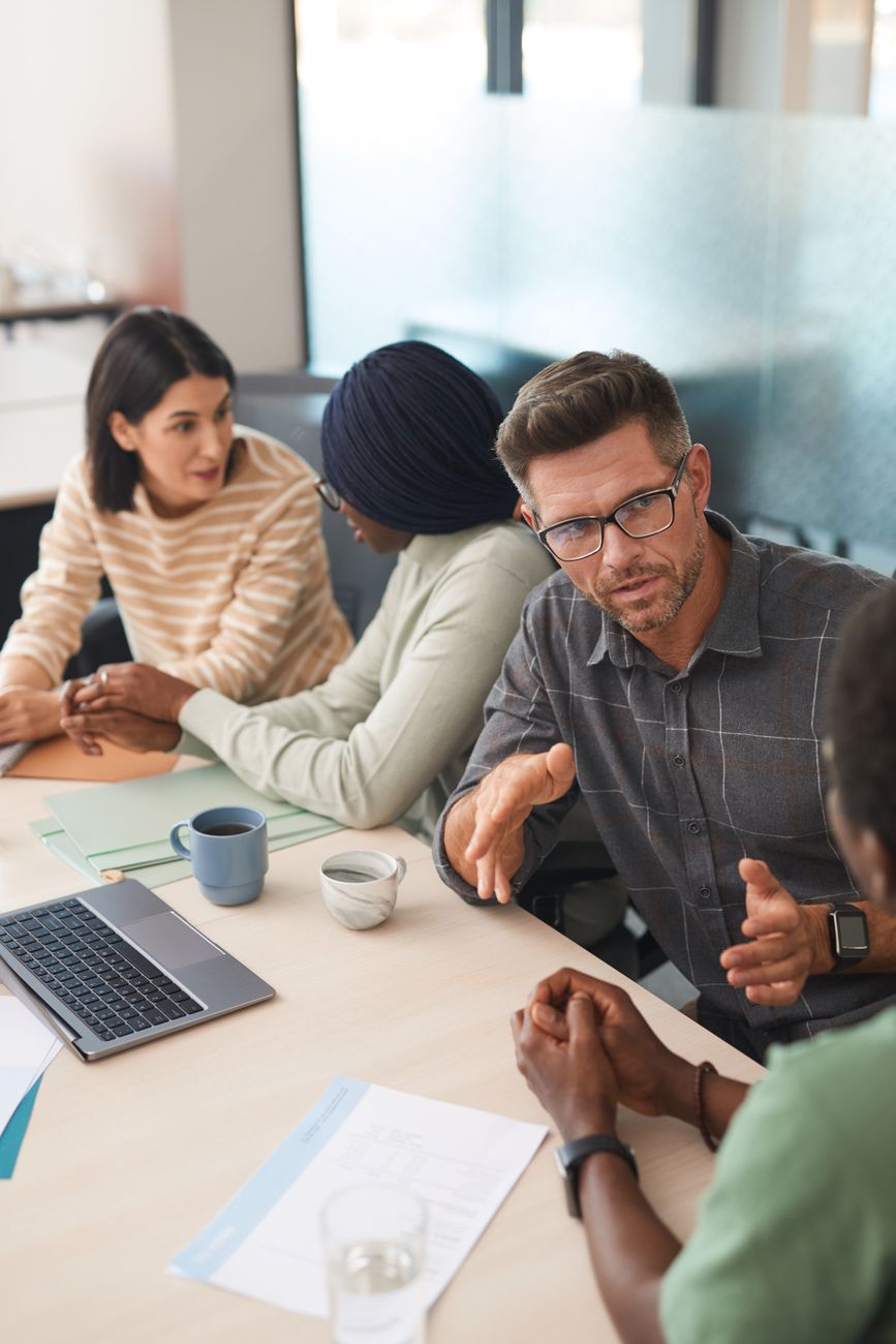 a group of people having a meeting in the office