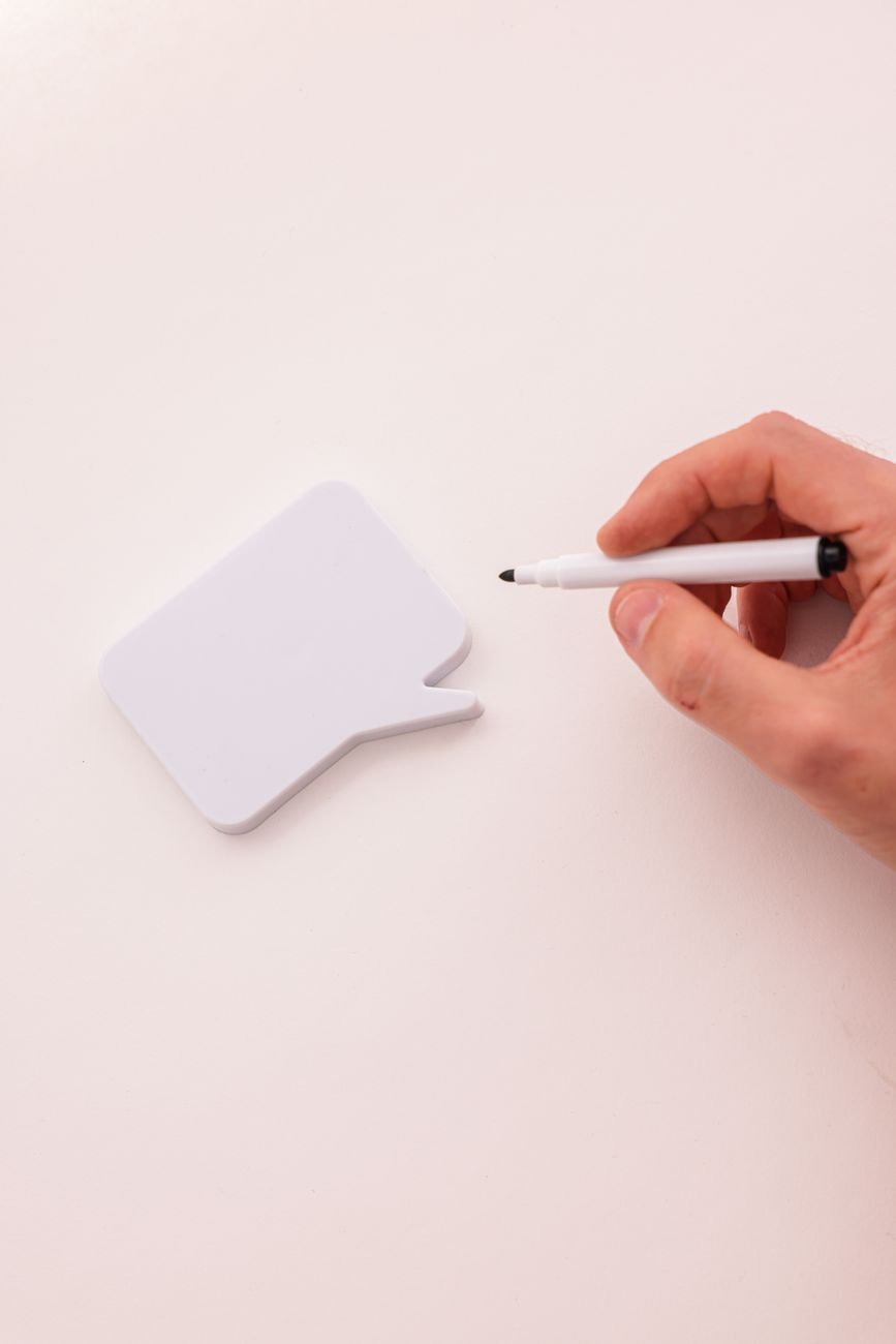 hand with marker over chat box