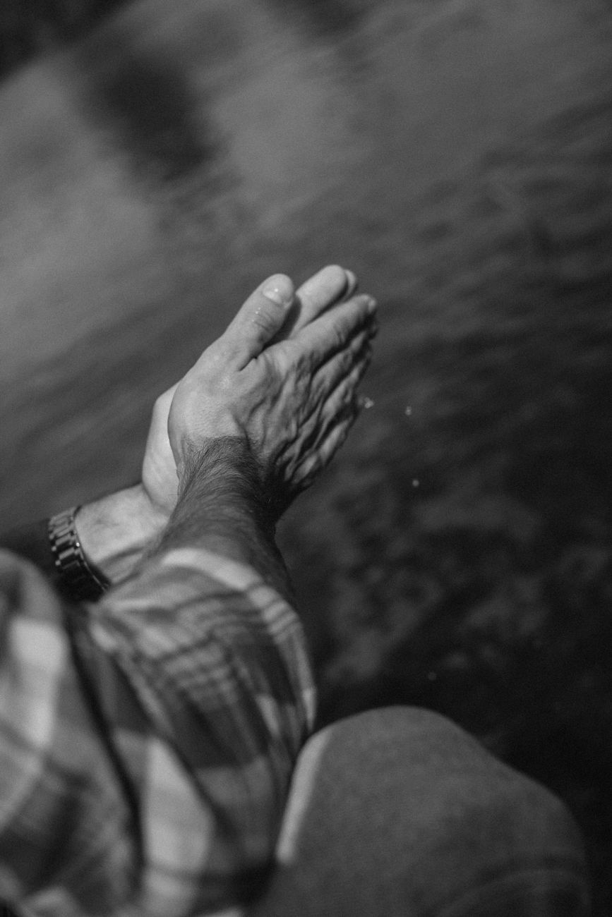 grayscale photo of a person s hands