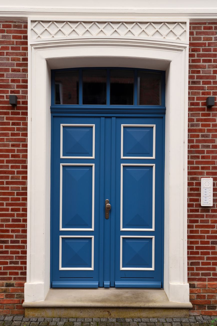 blue doors of a brick house
