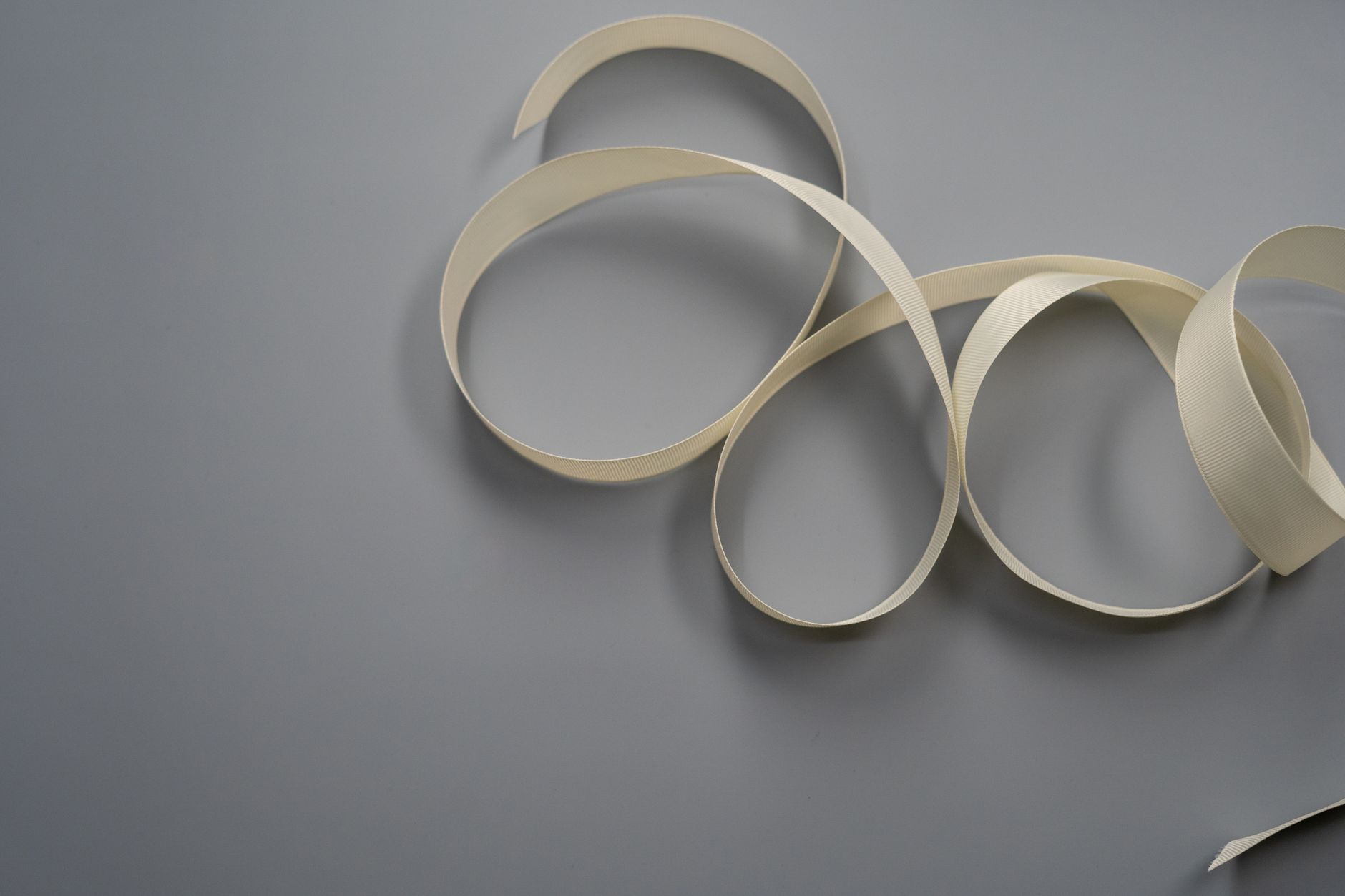 white ribbon on gray surface
